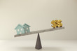 3D rendering of abstract house and dollar on balance scale