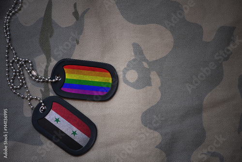 Stampe army blank, dog tag with flag of syria and gay rainbow flag on the khaki texture background