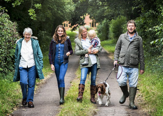 Canvas Print - Family Walking Dog Togetherness Nature Concept