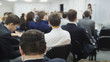 © KONSTANTIN SHISHKIN - Conference - lecturer tells presentation on the scene for crowd of listeners