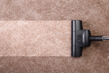 Vacuuming Carpet With Vacuum Cleaner. Housework Service. Close Up Of The Head Of A Sweeper Cleaning Device.