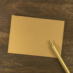 Wall Mural - Brown kraft cardboard card with ink pen and copyspace