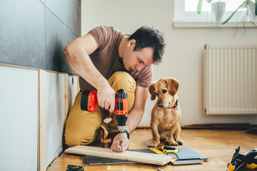 Man and his dog doing renovation work at home