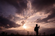 © songphon - Silhouette man with backpack use smartphone in hands at sunset background, Travel concept.