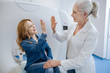 © zinkevych - Happy attractive woman giving her doctor a high five