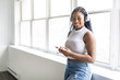 © Louis-Paul Photo - young teen beautiful African American woman enjoys listening to music with headphones