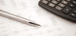 © axynia - Accounting concept. Pen and calculator on a numbers background