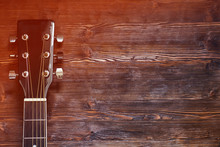 Black Acoustic Guitar On Wooden Background