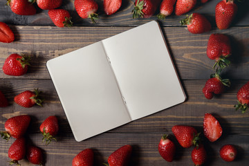Stylish branding mockup to display your artworks.  Have a blank notebook and strawberries. Horizontal view