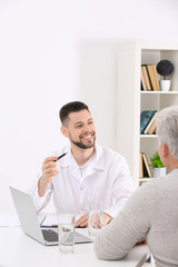 Sticker - Young positive insurance agent dealing with client in light office