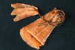 Smoked salmon fish on a slate board. Top view at cutted slices of smoked salmon