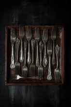 Overhead View Of Forks Arranged In Tray On Table