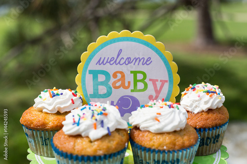Cupcakes With White Cream Glaze With Powder And Sprinkles For Baby