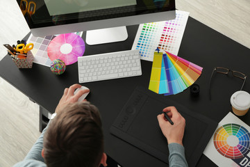 Canvas Print - Young male designer working in office