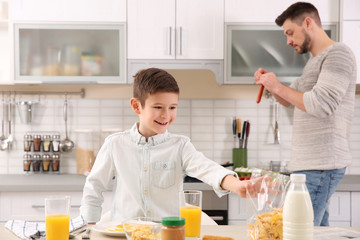 Wall Mural - Dad and son preparing to have lunch at home