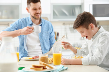 Wall Mural - Dad and son having lunch at home