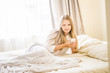 © Alena Yakusheva - indoor portrait of young pretty happy woman with a cup of tea or coffee in bed, morning at home