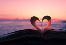 Heart From Book Against A Beautiful Sunset. 