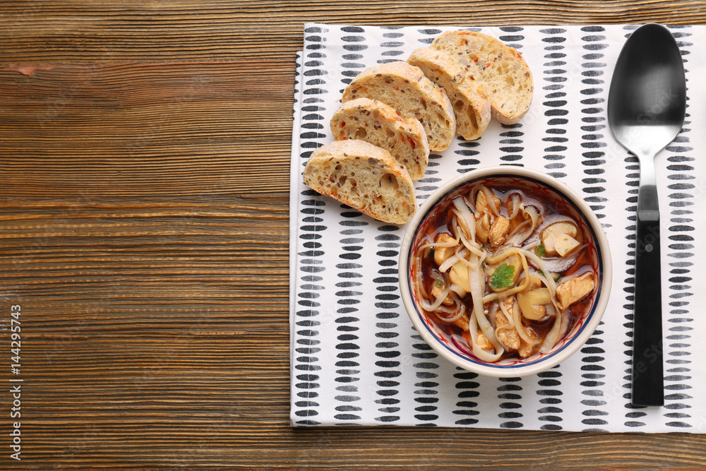 Bowl of chicken noodle soup served on table for dinner