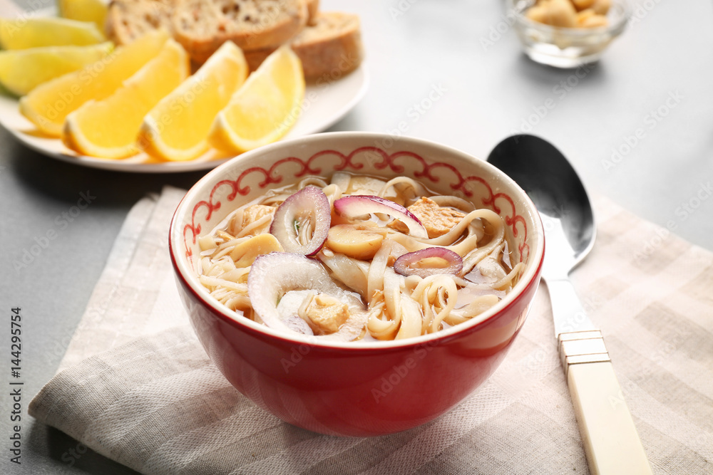Chicken noodle soup in bowl on kitchen table