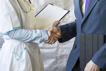 Poster - Business handshake. Businessman shaking hands with doctor shaking hands