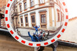 © EdNurg - Group of friends having fun with their reflection in a convex security road mirror.
