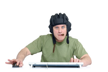 Funny man in tank helmet and cigar playing in game, sitting front of computer. Isolated on white background.