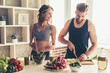 Leinwandbild Motiv Couple cooking healthy food