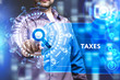 Business, Technology, Internet and network concept. Young businessman working on a virtual screen of the future and sees the inscription: Taxes