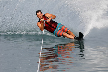 A slalom waterskier turning hard