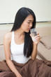 © Bavorndej - Beautiful asian woman drinking water, Young woman portrait in bedroom.
