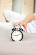 © Jestercine - Hand man reaching out for alarm clock on morning.