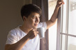 © Jestercine - Asian man drinking coffee with coffee cup in morning time.