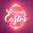 © garrykillian - The Easter shining egg of glowing points. Sparkling egg on colorful violet background with tiny flares and beautiful handwritten calligraphy. Happy Easter lettering.