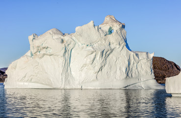 Iceberg in the Disco Bay, Greenland. Their source is by the Jakobshavn glacier. This is a consequence of the phenomenon and catastrophic thawing of ice. Ilulissat on background