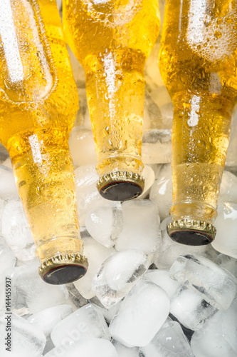 Fototapeta na wymiar Bottles of cold and fresh beer with ice