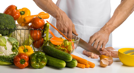 man hand cook cut chicken meat ( chicken breast) and salad on kitchen