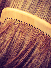 Straight Brown Hair With Wooden Comb Closeup