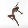 Young slim gymnast in studio on white background