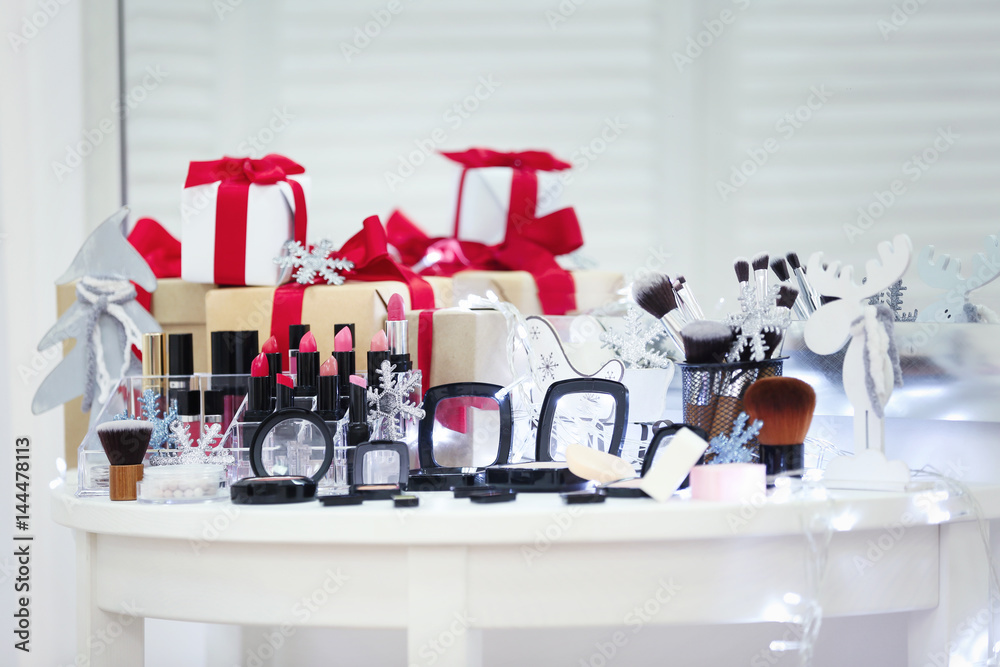 Set of decorative cosmetics with gift boxes on table