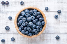 Bowl Of Fresh Blueberries On Vintage White Background. Top View
