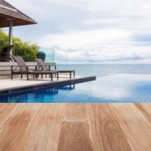 Wood Table Top On Blur Beach Chair In Outdoor With Swimming Pool And Sea View Andaman Sea.