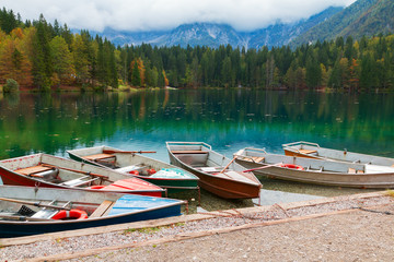 Beautiful Lago di Fusine the mountain lake at boat and Mangart mountain in the background