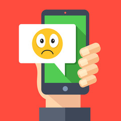 Poster - Hand holding smartphone with sad emoji message on screen. Sad emoticon icon. Social networking, instant messaging on mobile device, online chat concepts. Modern flat design vector illustration