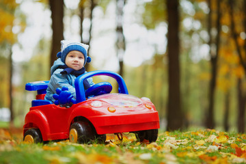 Wall Mural - little funny boy driving toy car