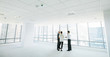 © Jacob Lund - Estate agent with clients inside an empty office space
