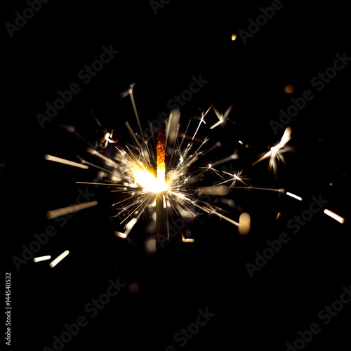 Fotografie, Obraz Glowing flow of sparkler, bokeh shine in the dark background