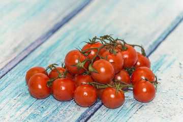 cherry tomatoes, on a blue rustic background