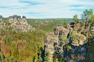  view of vertical rock formations surrounded by trees