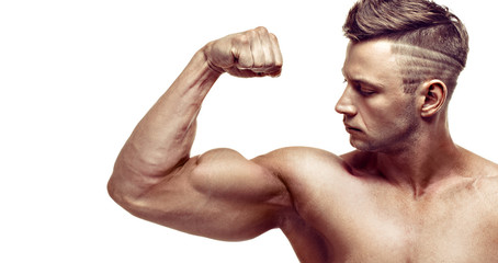 muscular super-high level handsome man posing on white background. showing his biceps.